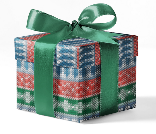 A gift box wrapped in customizable wrapping paper with a geometric pattern, predominantly in red, green, and blue, tied with a green ribbon.