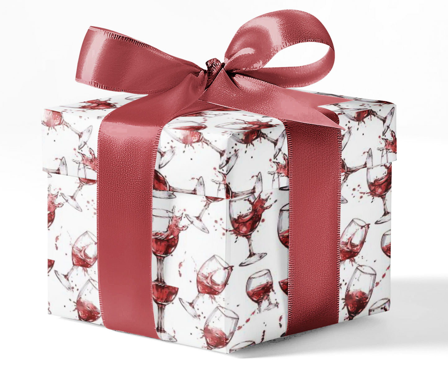 A gift box wrapped in custom wrapping paper with a pattern of wine glasses, tied with a red ribbon.
