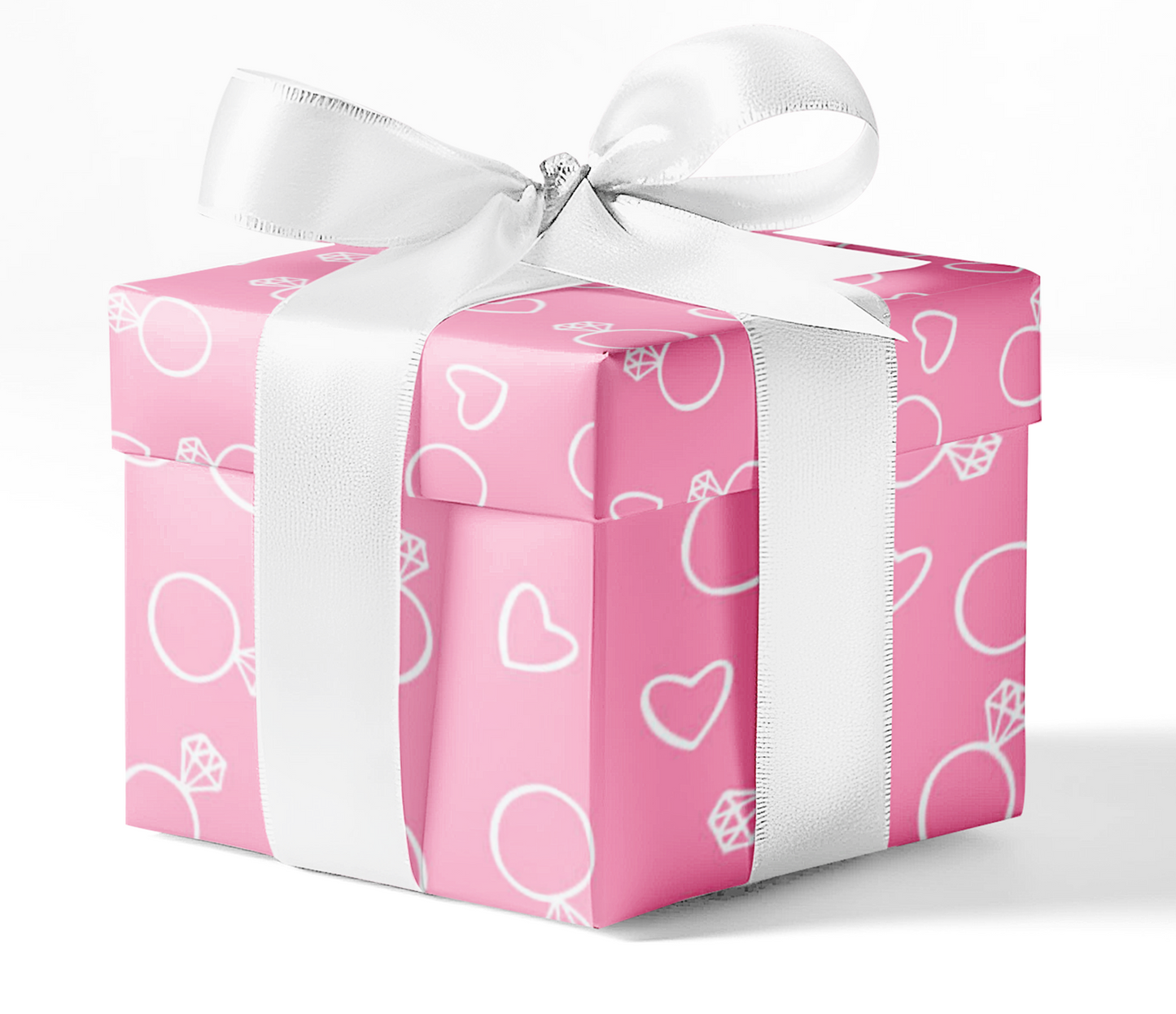 Gift box wrapped in pink custom wrapping paper with heart and ring icons, tied with a white satin ribbon – available at CustomMyPrints.com.