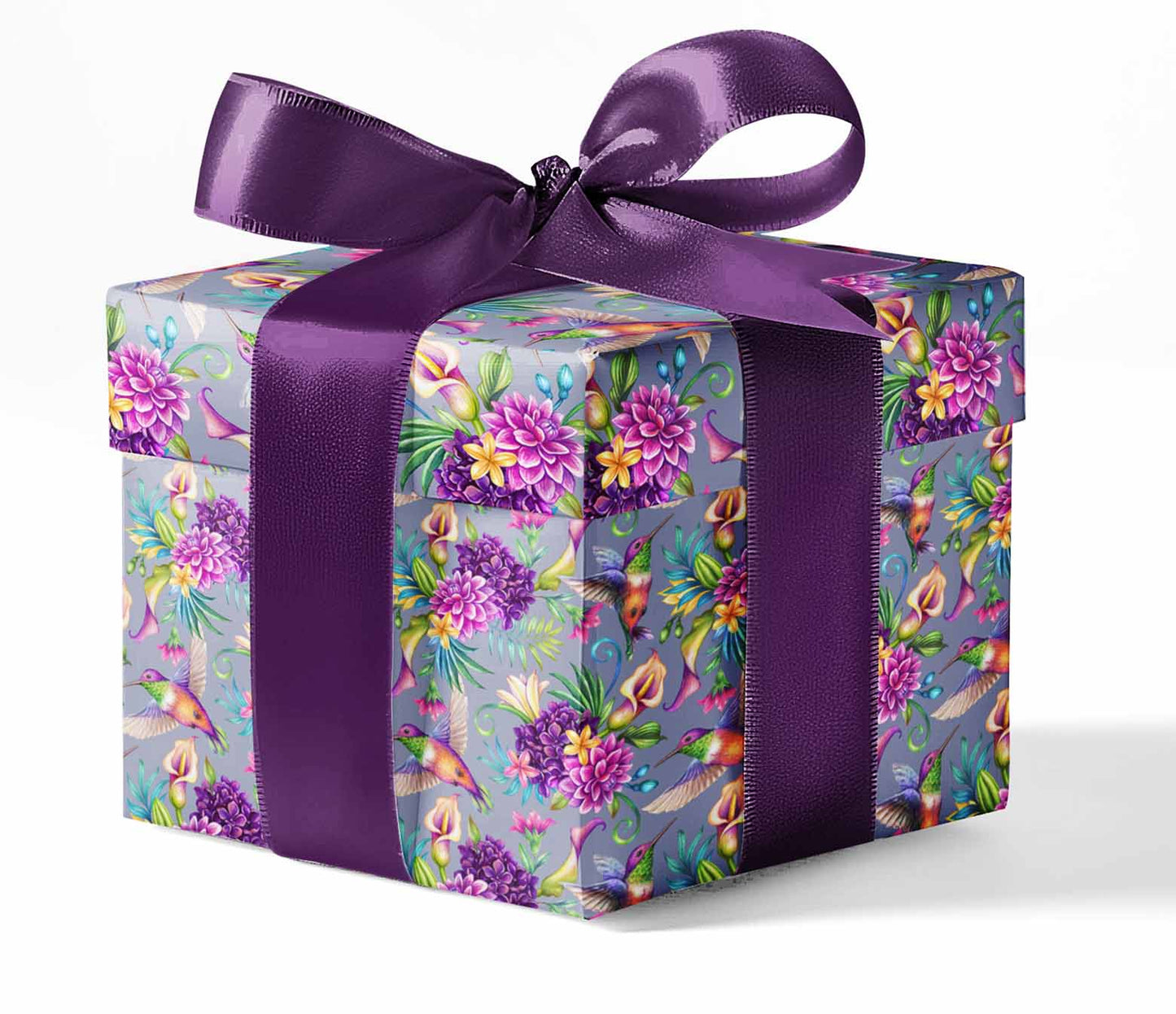 A gift box wrapped in custom wrapping paper with a floral pattern and a purple ribbon.