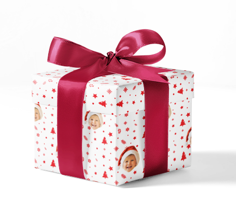A gift box wrapped in custom wrapping paper with a red and white pattern, including Christmas trees and Santa hats, tied with a red ribbon.