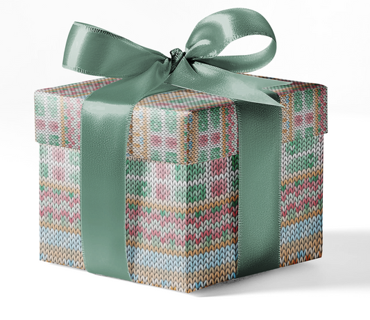 A gift box wrapped in custom wrapping paper with a geometric pattern, tied with a green ribbon.
