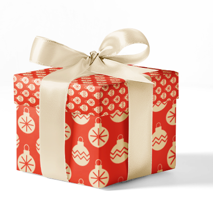 A gift wrapped in red custom wrapping paper with a Christmas ornament pattern, tied with a beige ribbon.
