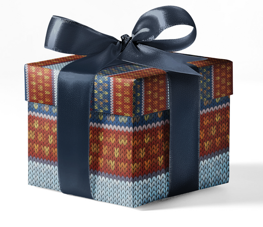 A gift box wrapped in custom wrapping paper with a geometric pattern, predominantly red, and tied with a blue ribbon.