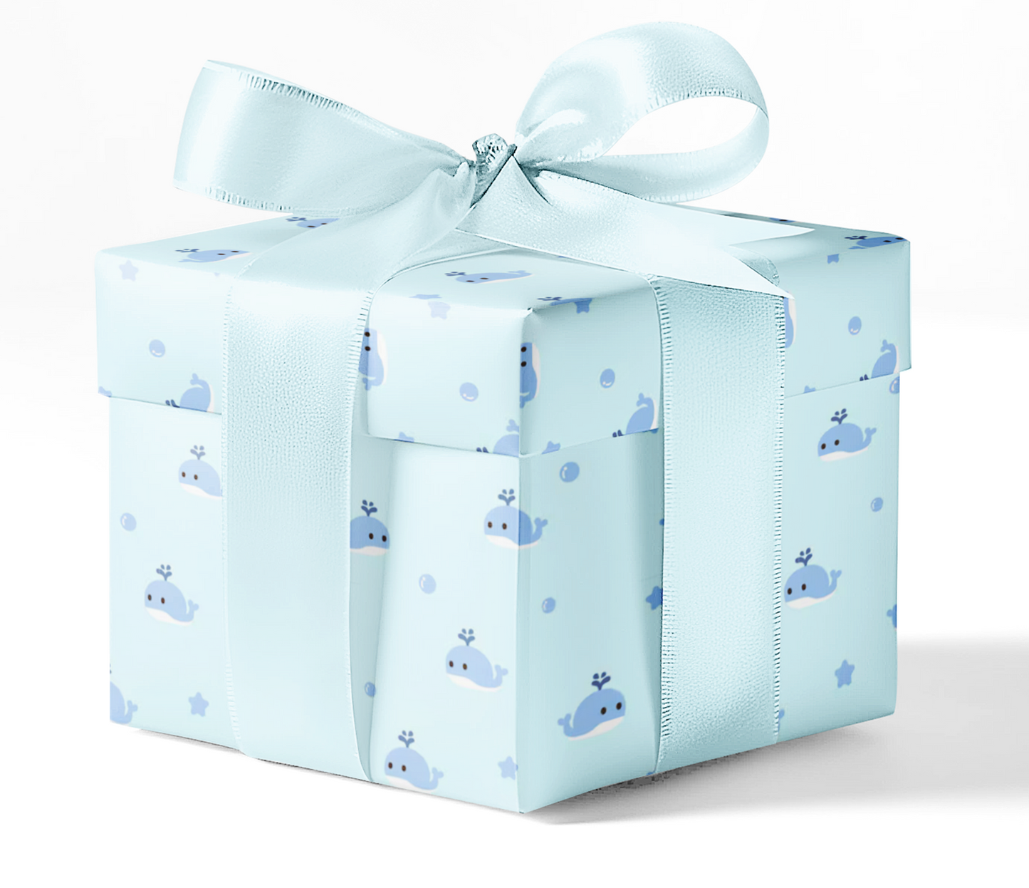 A gift box wrapped in blue wrapping paper with a pattern of whales and waves, tied with a blue ribbon.
