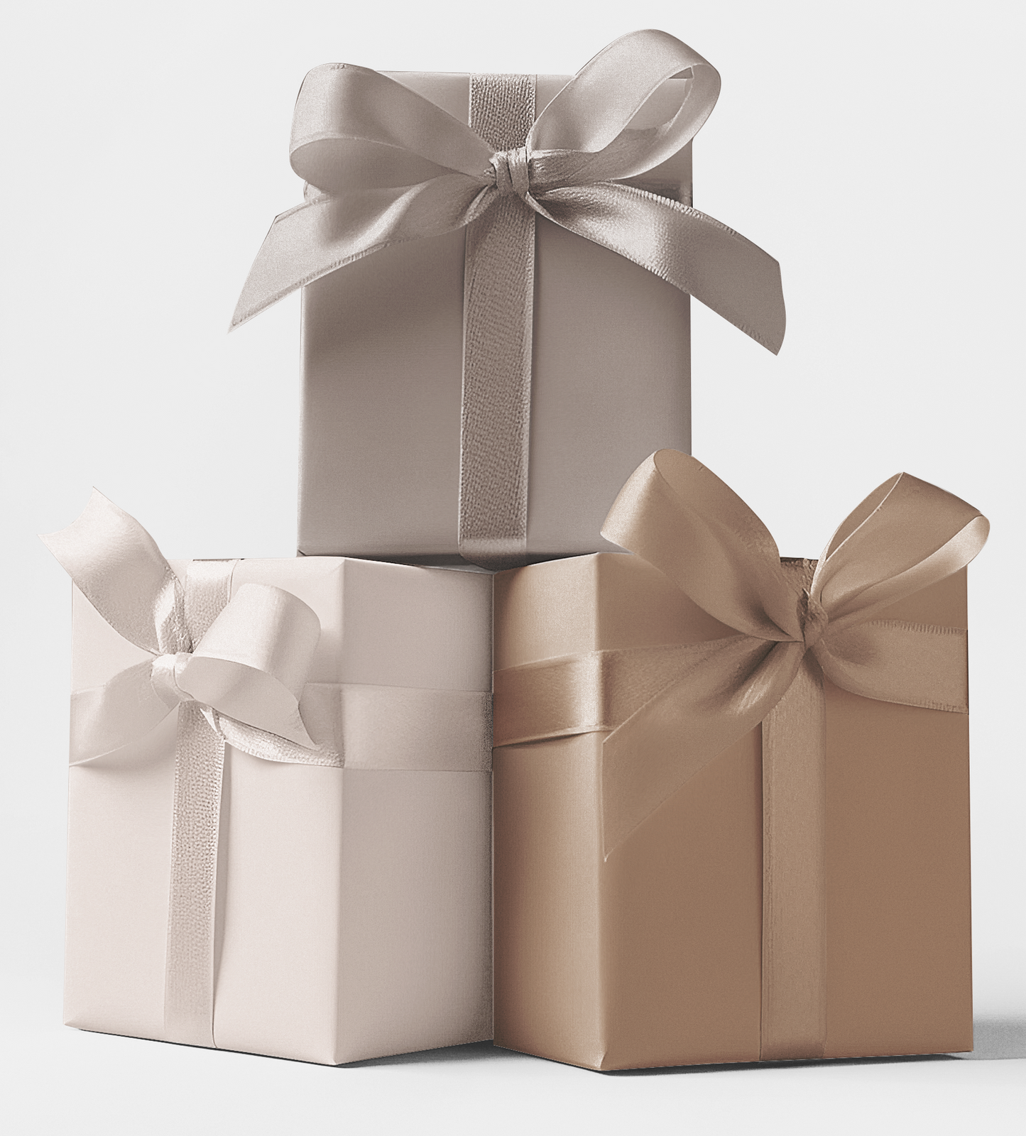 Three gift boxes wrapped in different shades of wrapping paper. The first box is silver with a satin finish, the second is beige with a matte finish, and the third is a combination of beige and brown with a matte finish.