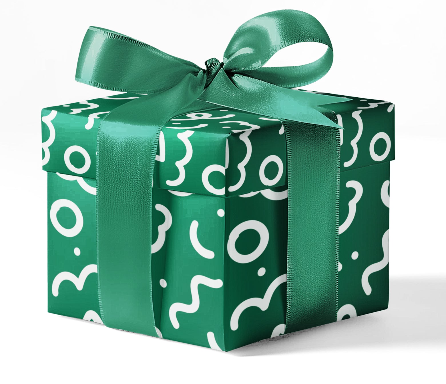 A gift box wrapped in green custom wrapping paper with a geometric pattern and tied with a ribbon.