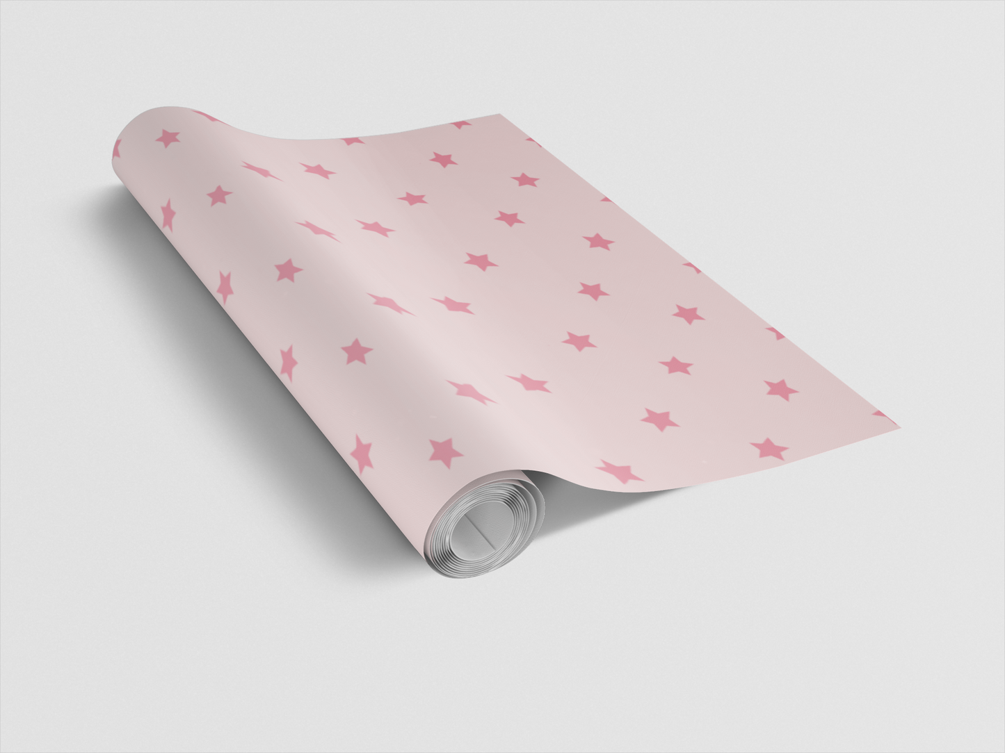 Roll of pink paper with star pattern on a light gray background