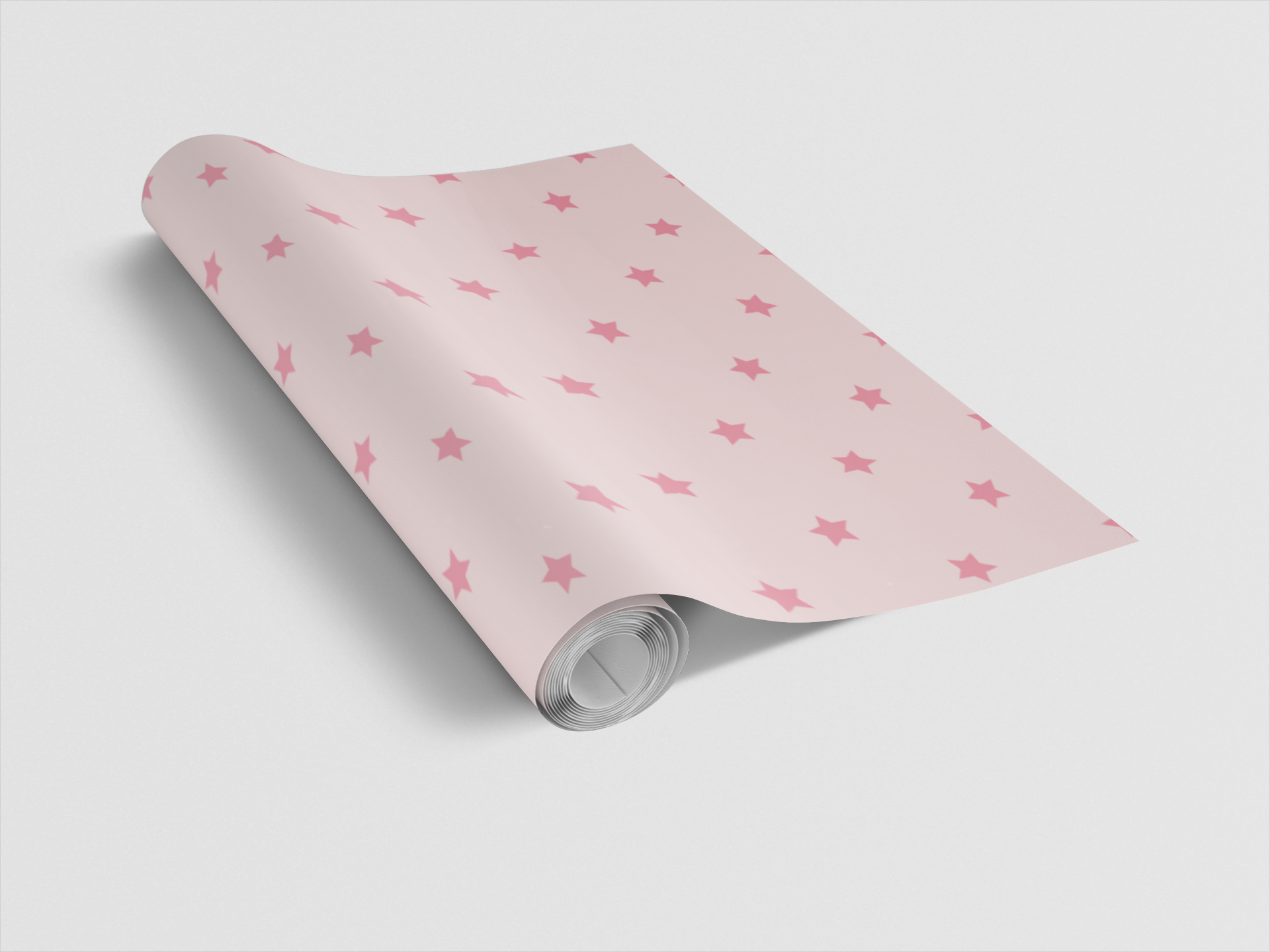 Roll of pink paper with star pattern on a light gray background