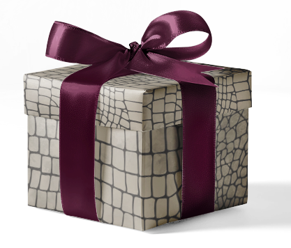 A gift box wrapped in customizable wrapping paper with an animal print pattern and tied with a purple ribbon.