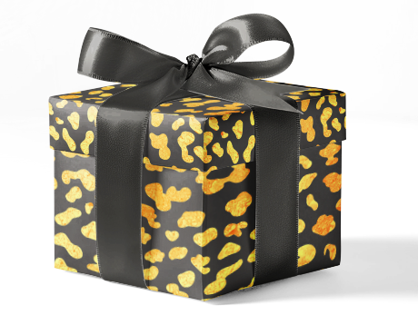 A gift box wrapped in black and yellow animal print wrapping paper with a black ribbon.