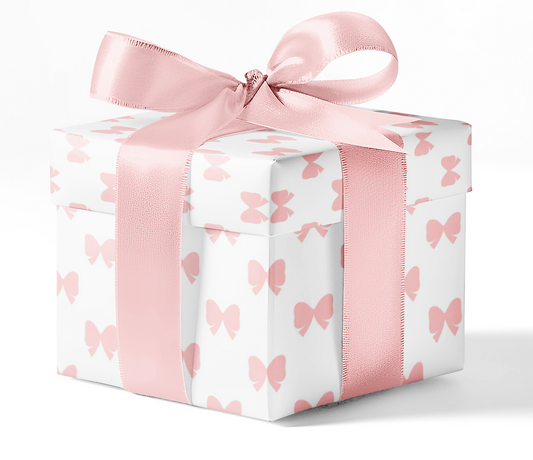 A gift box wrapped in custom wrapping paper with a pattern of pink bows and a pink ribbon.