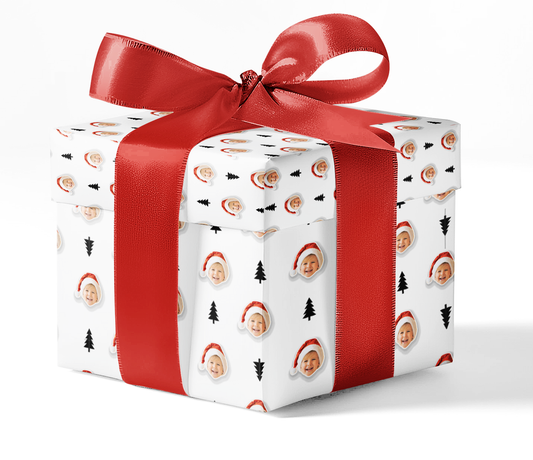 A gift box wrapped in black and white pine patterned wrapping paper with a red ribbon.