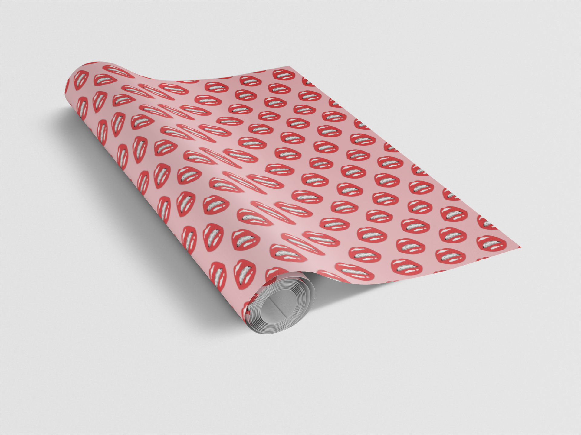 Roll of pink wrapping paper with red lip print on a light gray background