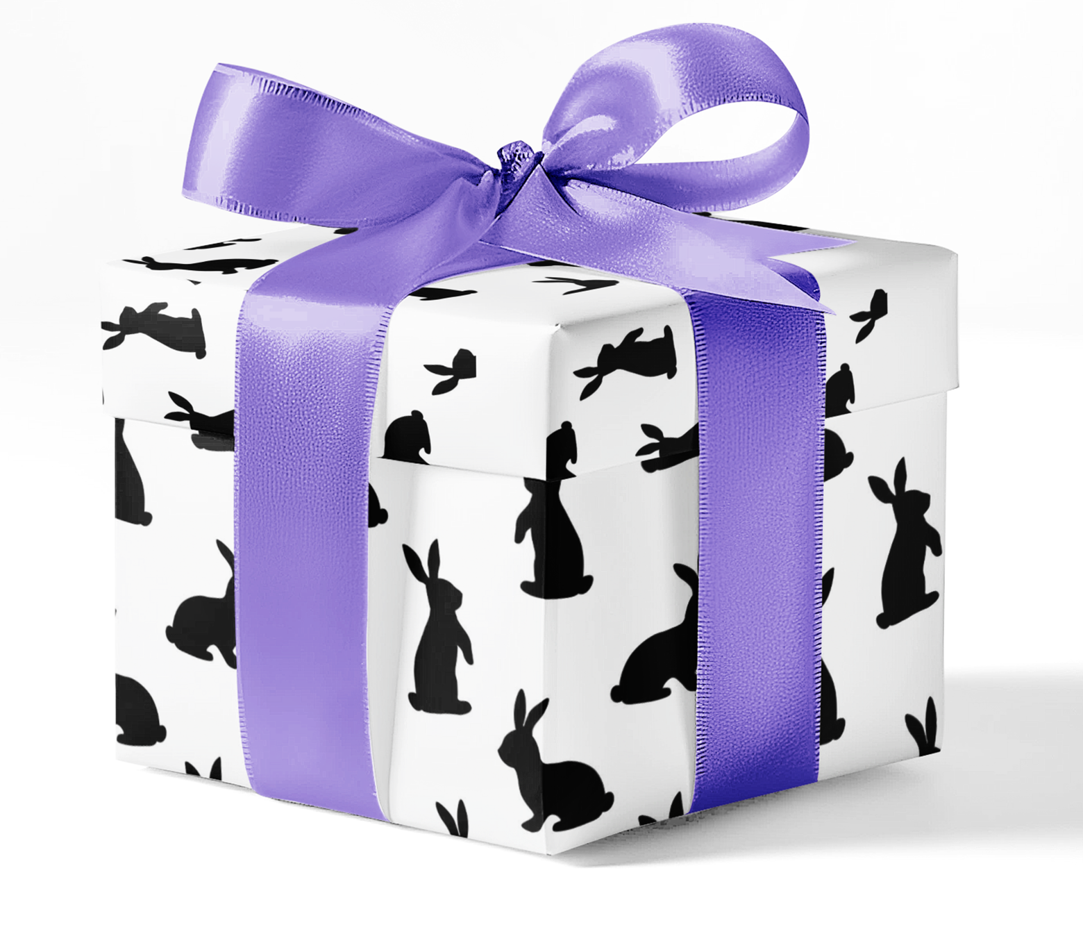A gift box wrapped in black and white wrapping paper with a pattern of rabbits and rabbits holes, tied with a purple ribbon.
