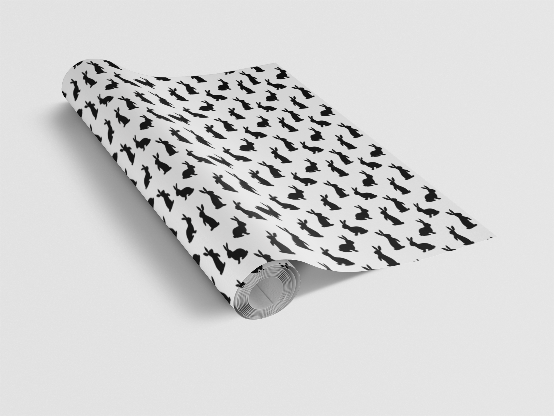 Roll of wallpaper with black dog pattern on white background