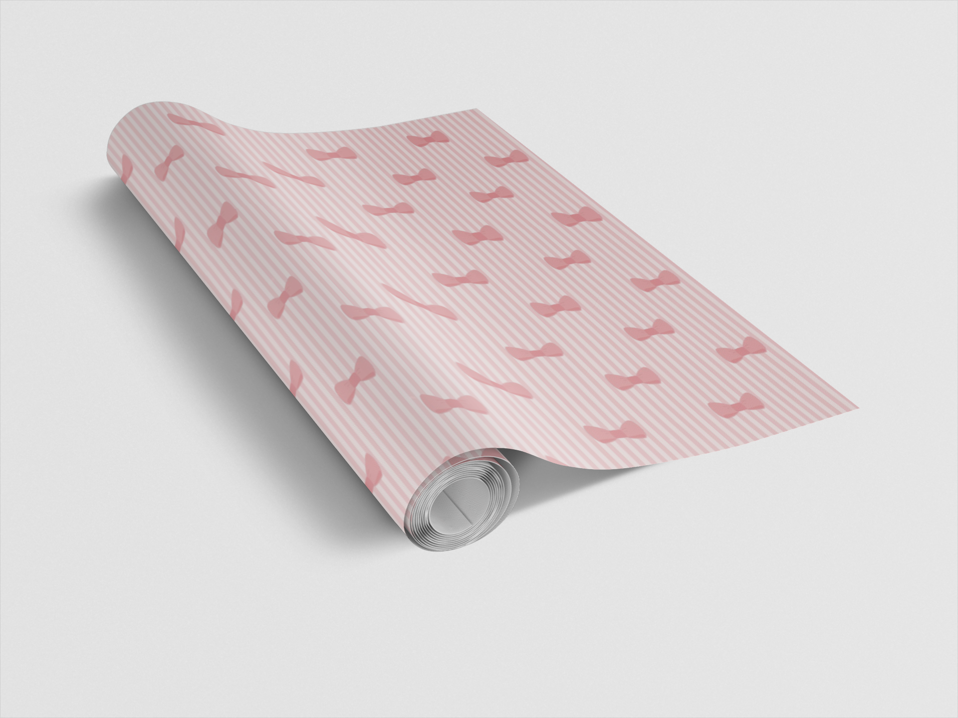 Roll of pink patterned paper on a light gray background