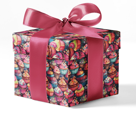 A gift box wrapped in custom wrapping paper with a colorful cupcake pattern, tied with a pink ribbon.
