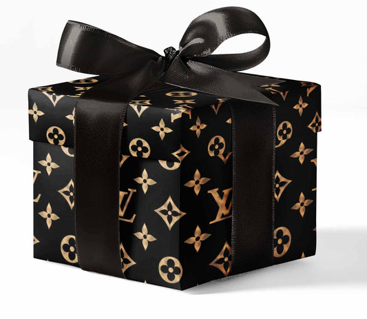 Black gift box with gold pattern and black ribbon on a white background