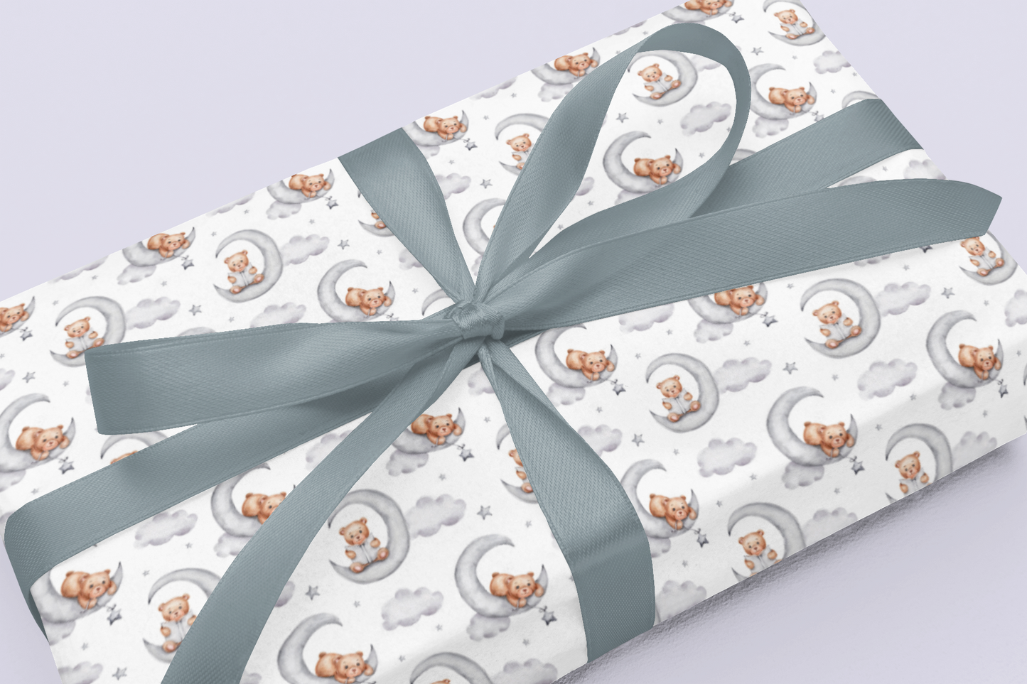 Gift wrap with teddy bear pattern and gray ribbon on a light purple background