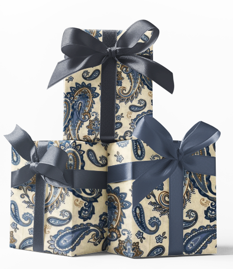 Stack of three gift boxes wrapped in blue and gold paisley patterned wrapping paper with black bows.