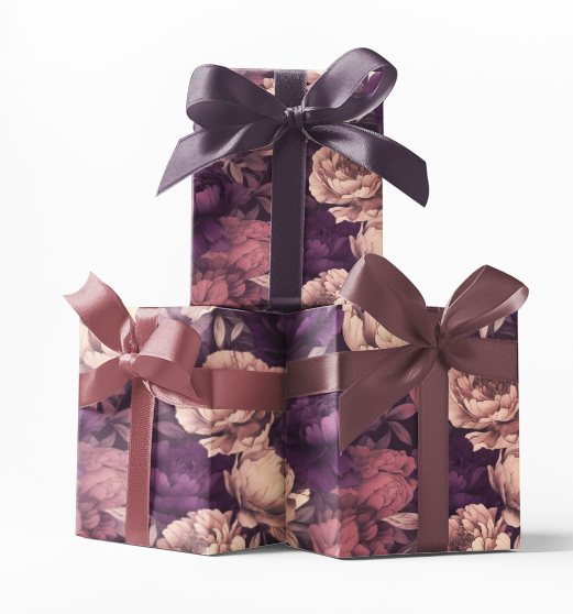Stacked gift boxes wrapped in custom purple wrapping paper with a floral pattern, tied with a purple ribbon.