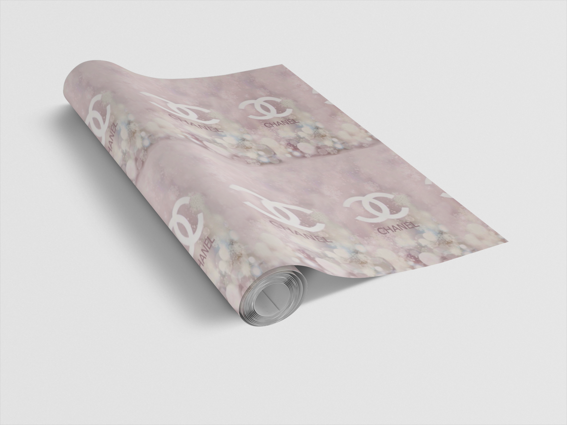 Roll of wrapping paper with a floral pattern and brand logo on a light gray background