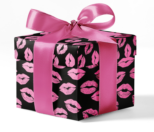 A gift box wrapped in black and pink wrapping paper with a pattern of lips and a pink ribbon.