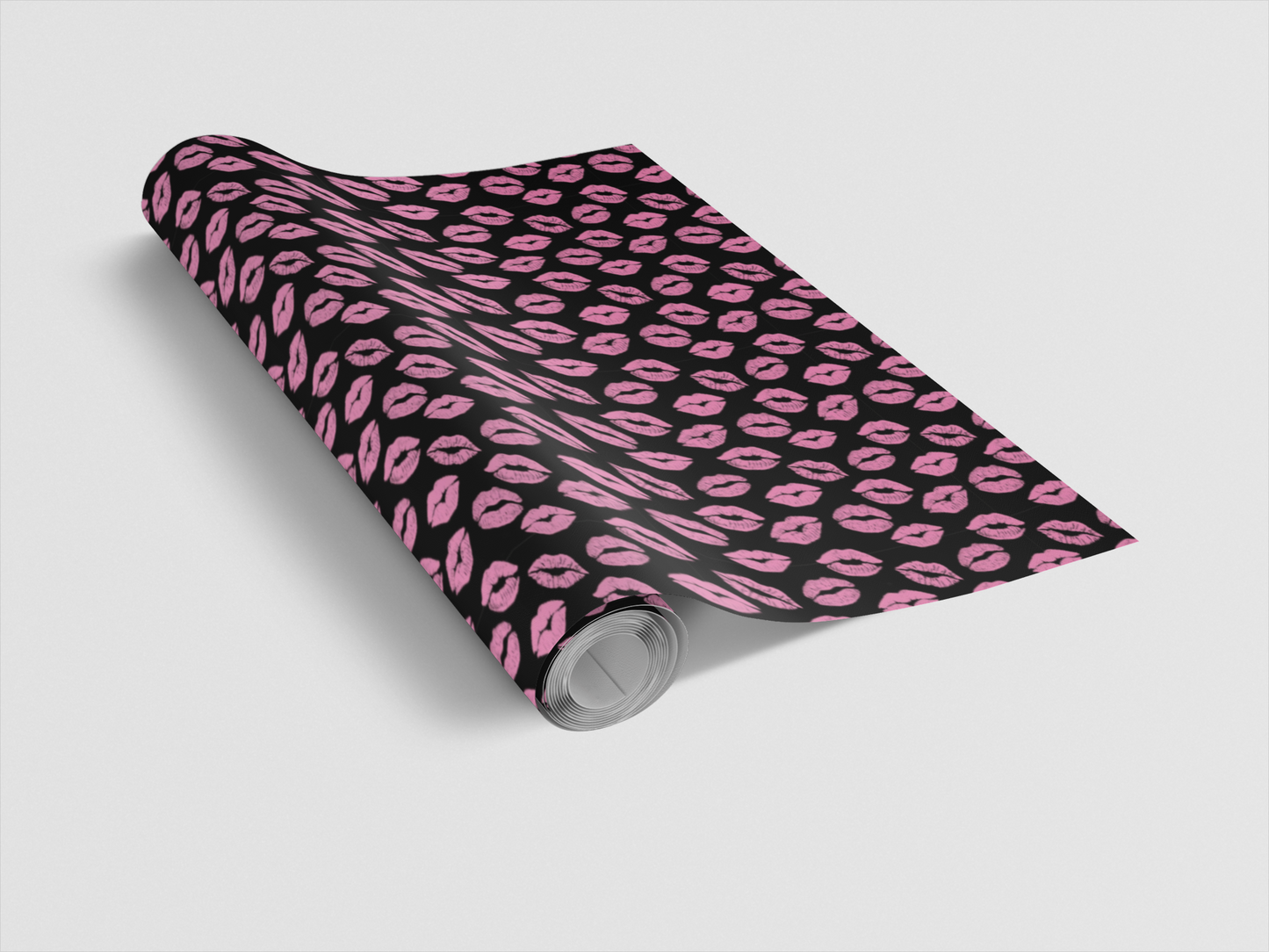 Roll of pink and black patterned paper on a white background