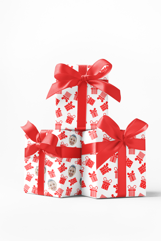 Stack of three wrapped gifts with red and white wrapping paper featuring a pattern of hearts and stars, tied with red ribbons.