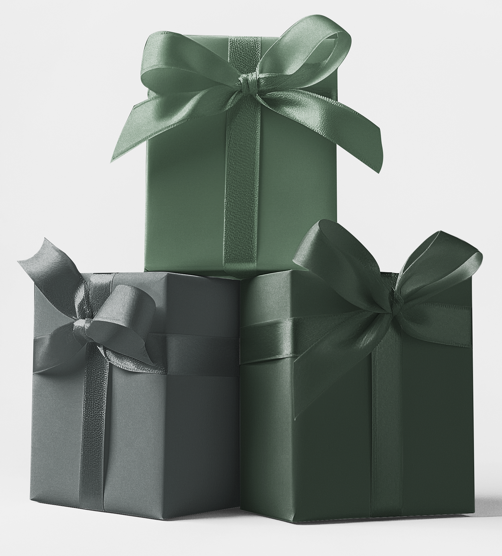 Three gift boxes stacked in order of size with ribbons, wrapped in green tones of wrapping paper.