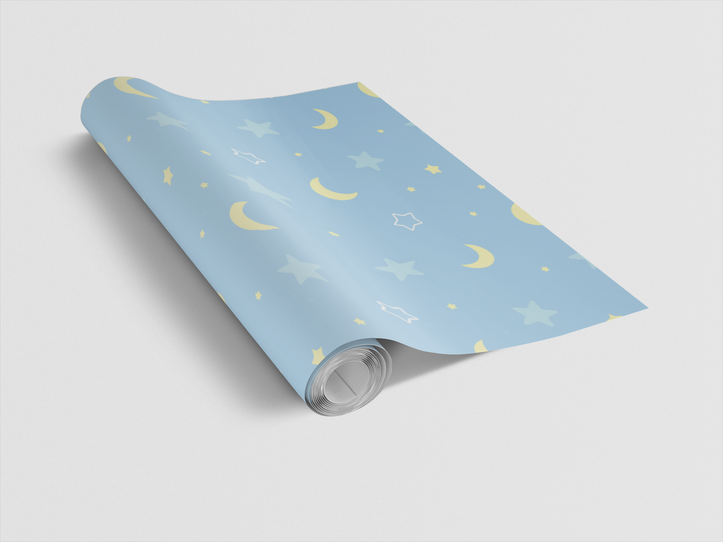 Roll of blue wrapping paper with yellow moon and star patterns on a light gray background