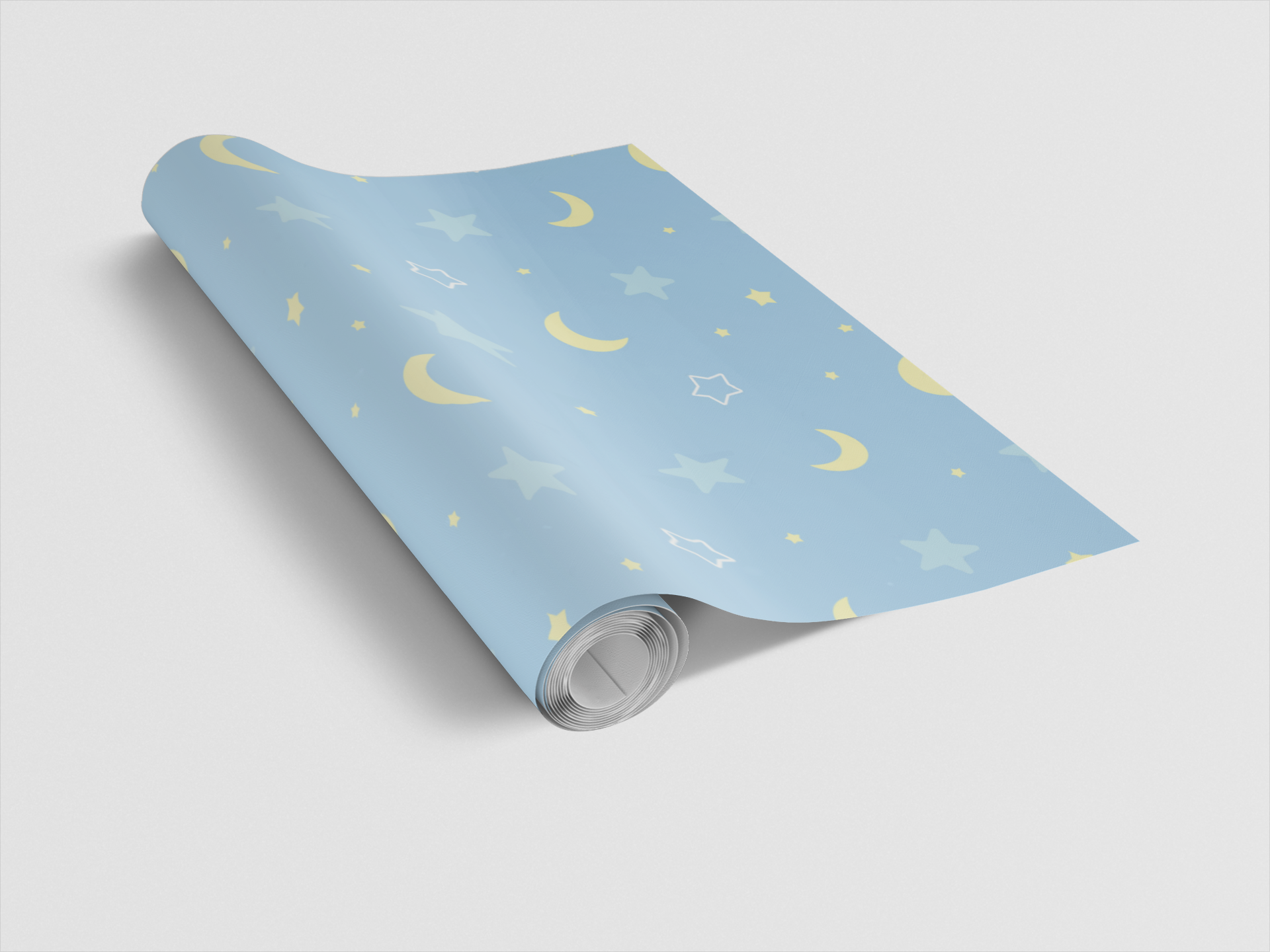 Roll of blue wrapping paper with yellow moon and star patterns on a light gray background