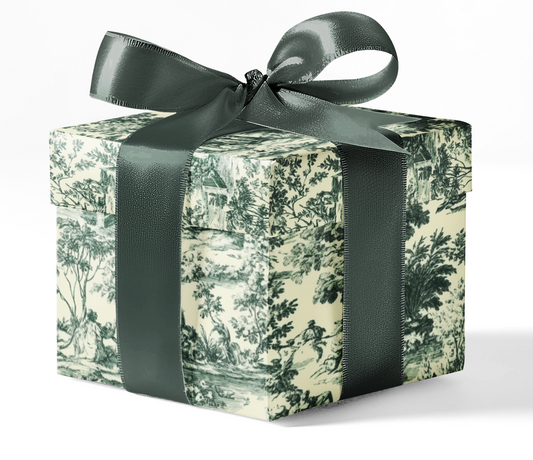 A box wrapped in green and white patterned custom wrapping paper with a dark green ribbon.