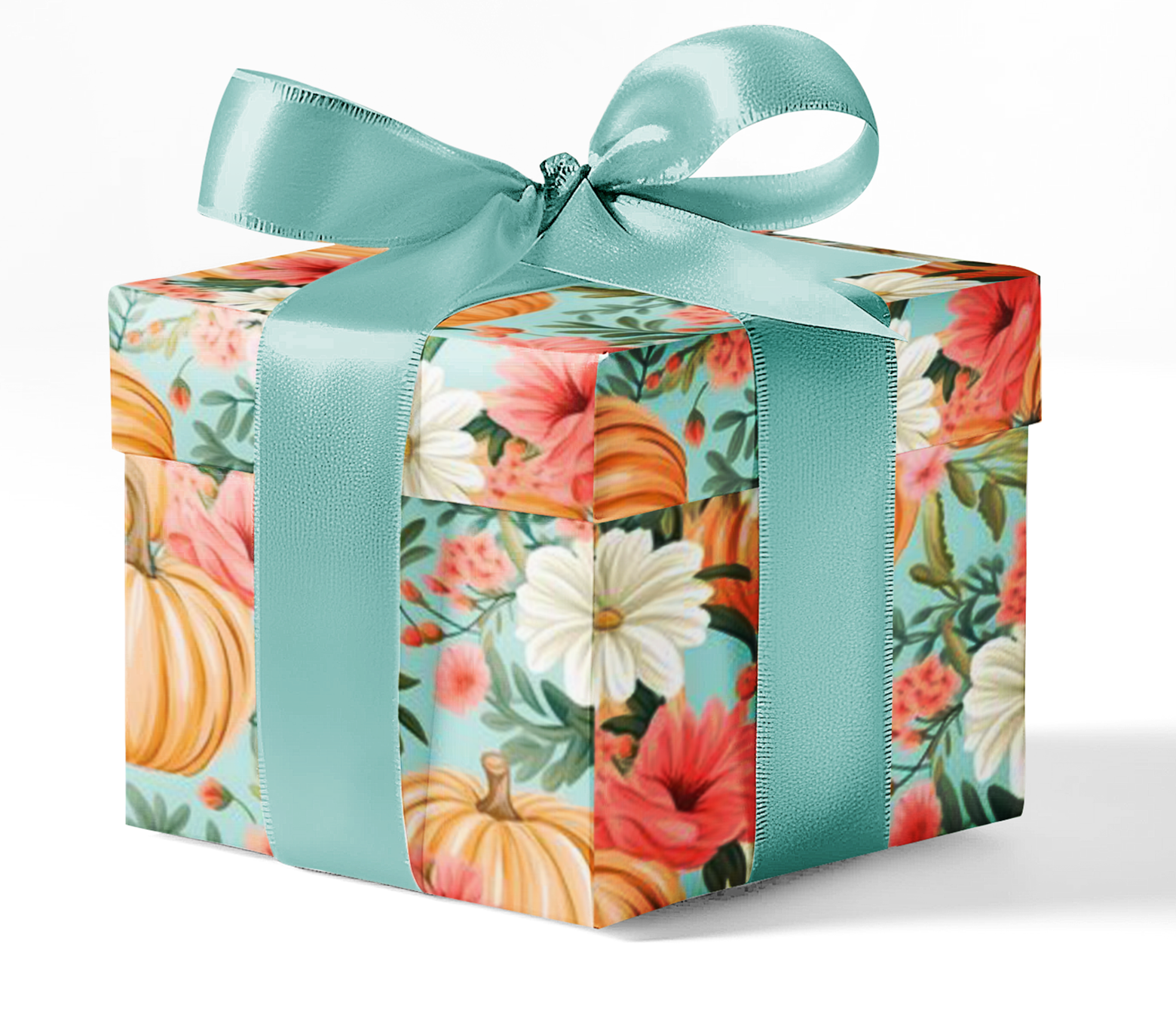 A gift box wrapped in custom wrapping paper with a floral and autumnal pattern, tied with a teal ribbon.
