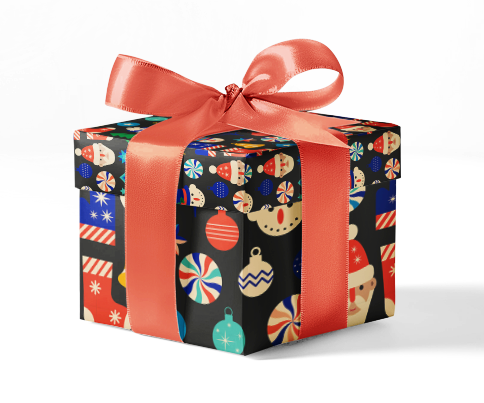 A gift box wrapped in custom wrapping paper with a multicolored pattern including Christmas-themed elements like ornaments and snowflakes, tied with a red ribbon.