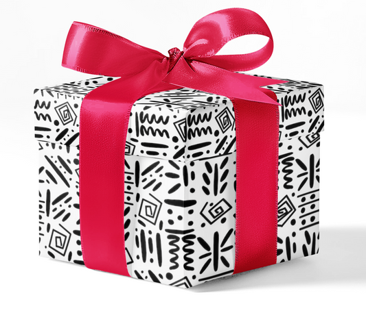A gift box wrapped in black and white patterned wrapping paper with a red ribbon bow on top.