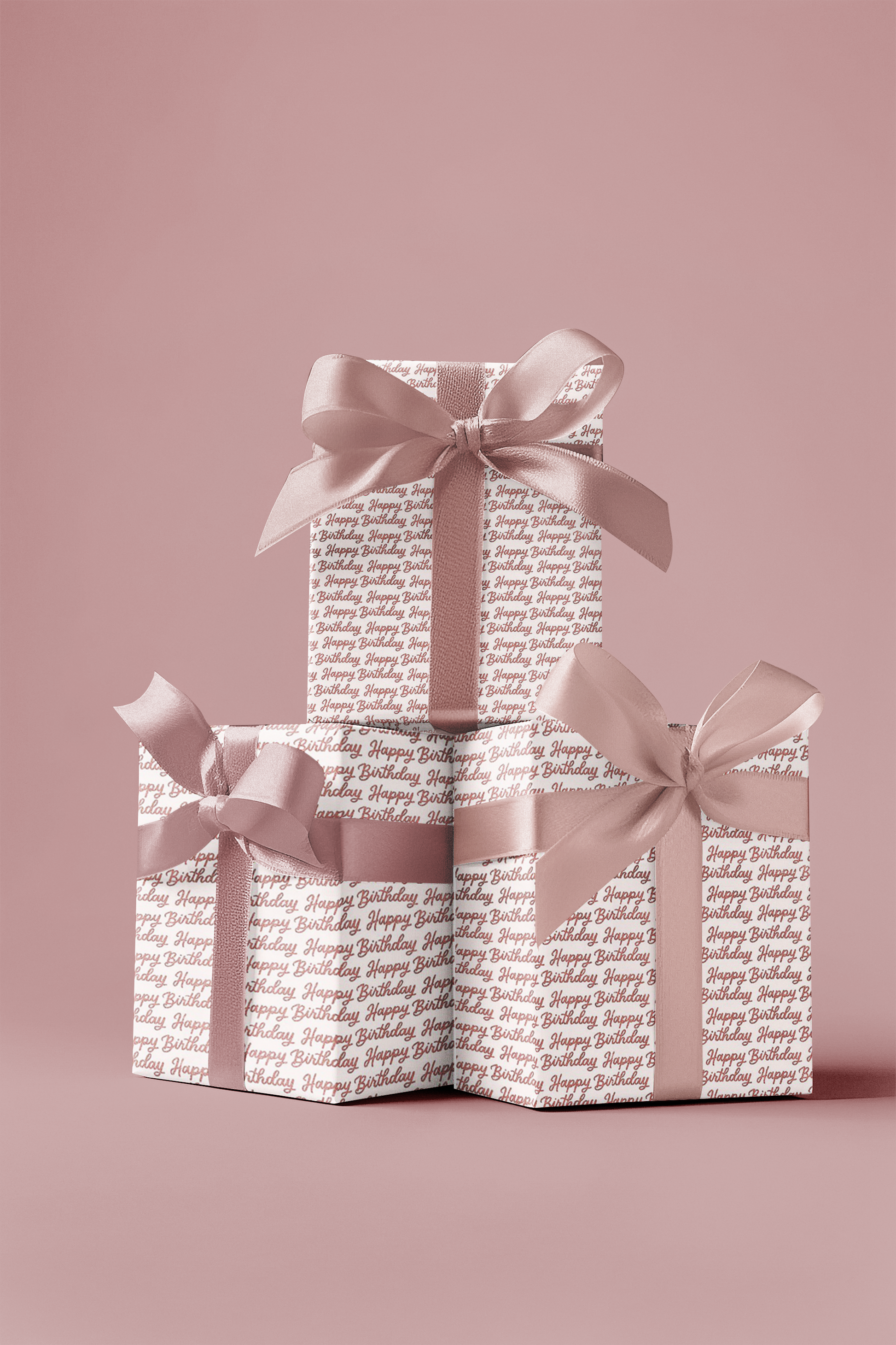 Stack of gift boxes with ribbons on a pink background