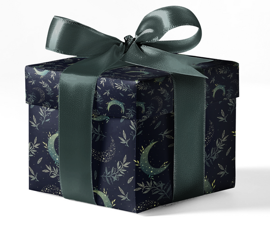A gift box wrapped in black wrapping paper with a green pattern featuring an animal and decorative elements, tied with a green ribbon.