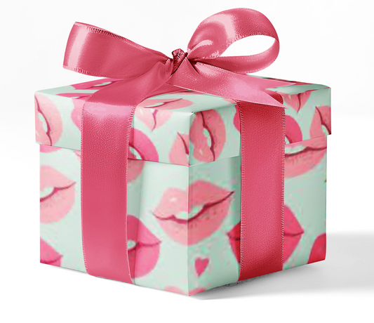 A gift box wrapped in custom wrapping paper with a pattern of lips and hearts, tied with a pink ribbon.