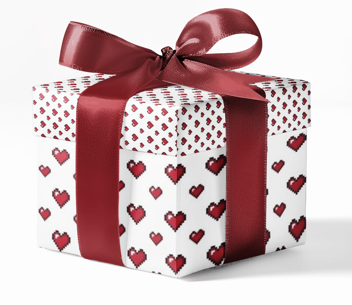 Gift box with red heart pattern and red ribbon on a white background