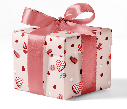 A gift box wrapped in customizable wrapping paper with a pattern of red and white hearts and a pink ribbon bow at the top.