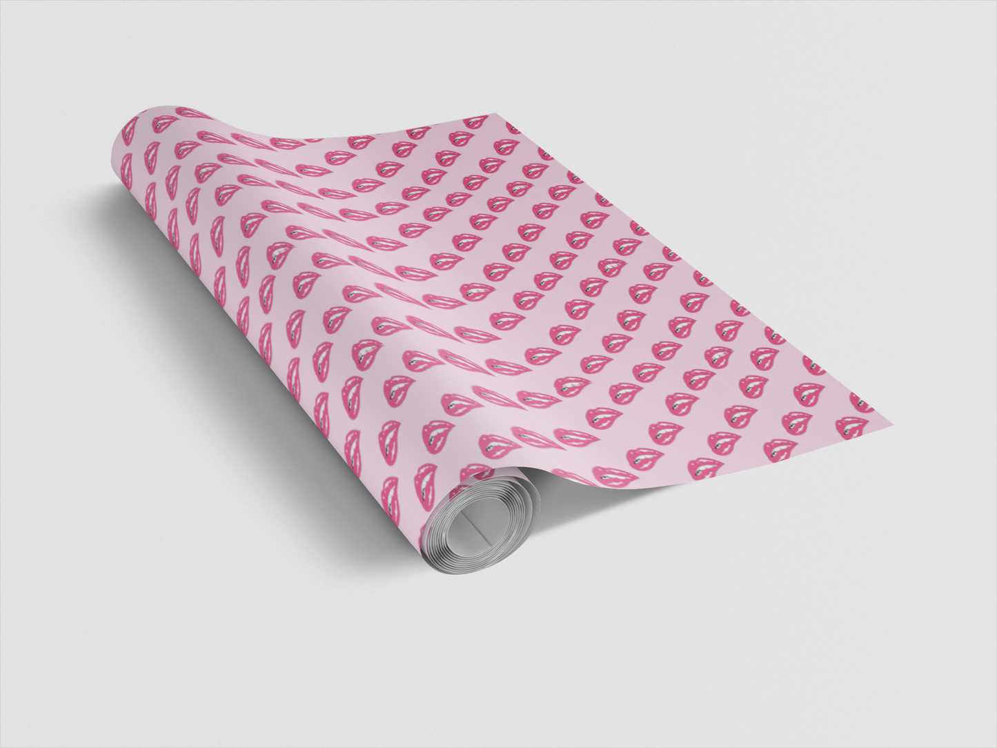 Roll of pink wrapping paper with heart pattern on a light gray background