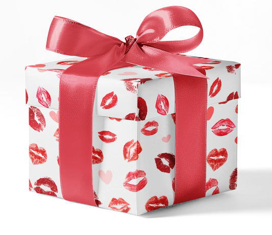 A gift box wrapped in customizable wrapping paper with a pattern of red lips and hearts, tied with a red ribbon.