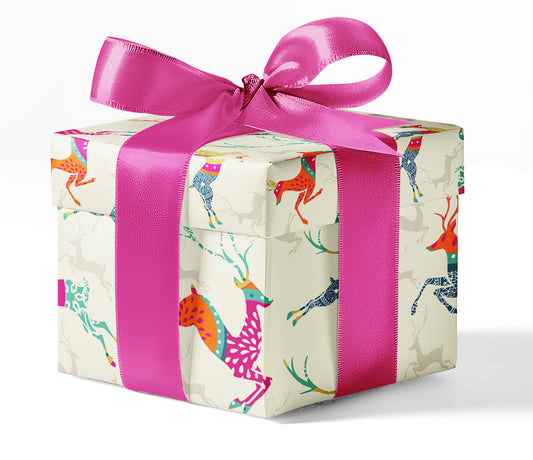 A gift box wrapped in custom wrapping paper with a multicolored reindeer pattern and a pink ribbon.