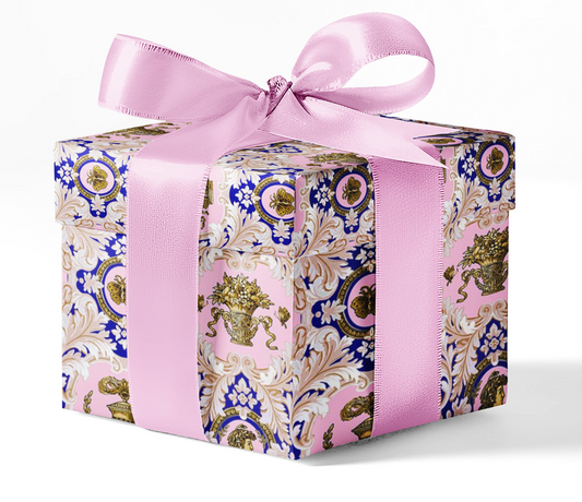 A gift box wrapped in custom wrapping paper with a floral pattern and a pink ribbon.