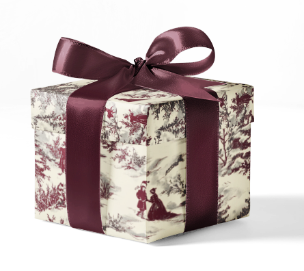 A gift box wrapped in custom wrapping paper with a red and white floral pattern and tied with a purple ribbon.