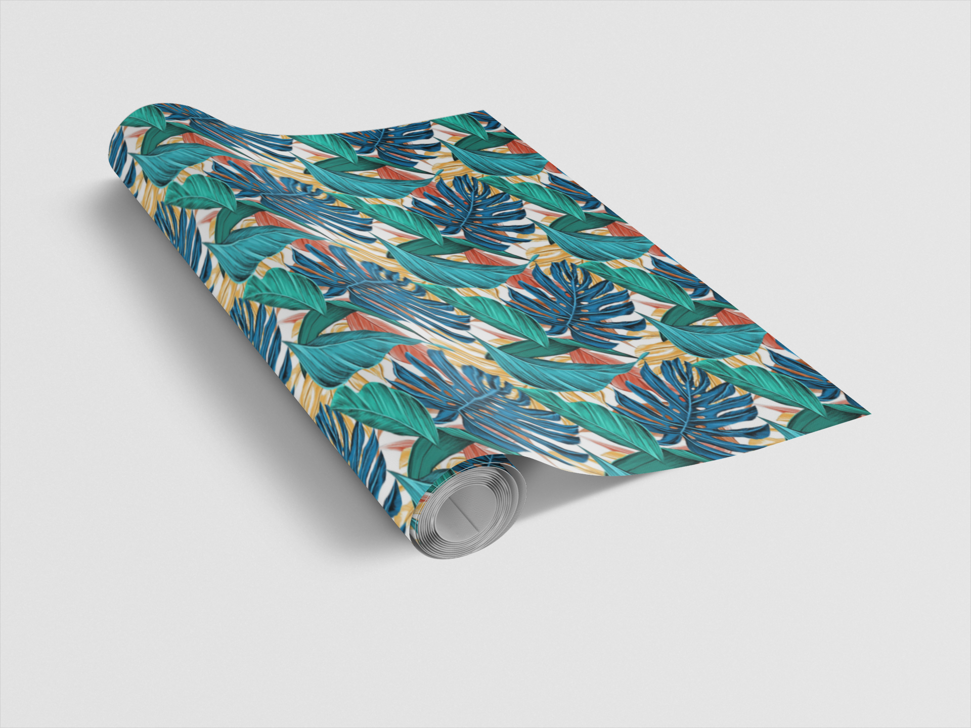 Roll of wrapping paper with a tropical leaf pattern on a light gray background