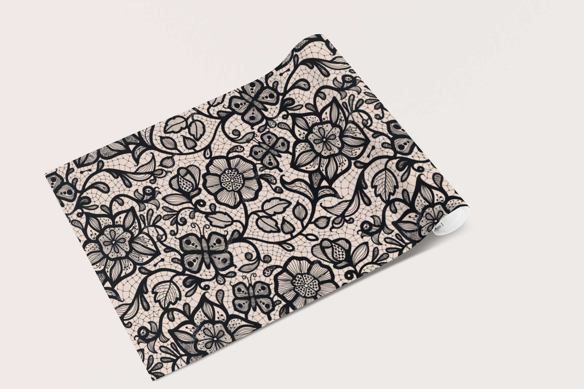 Folded fabric with black floral pattern on a beige background