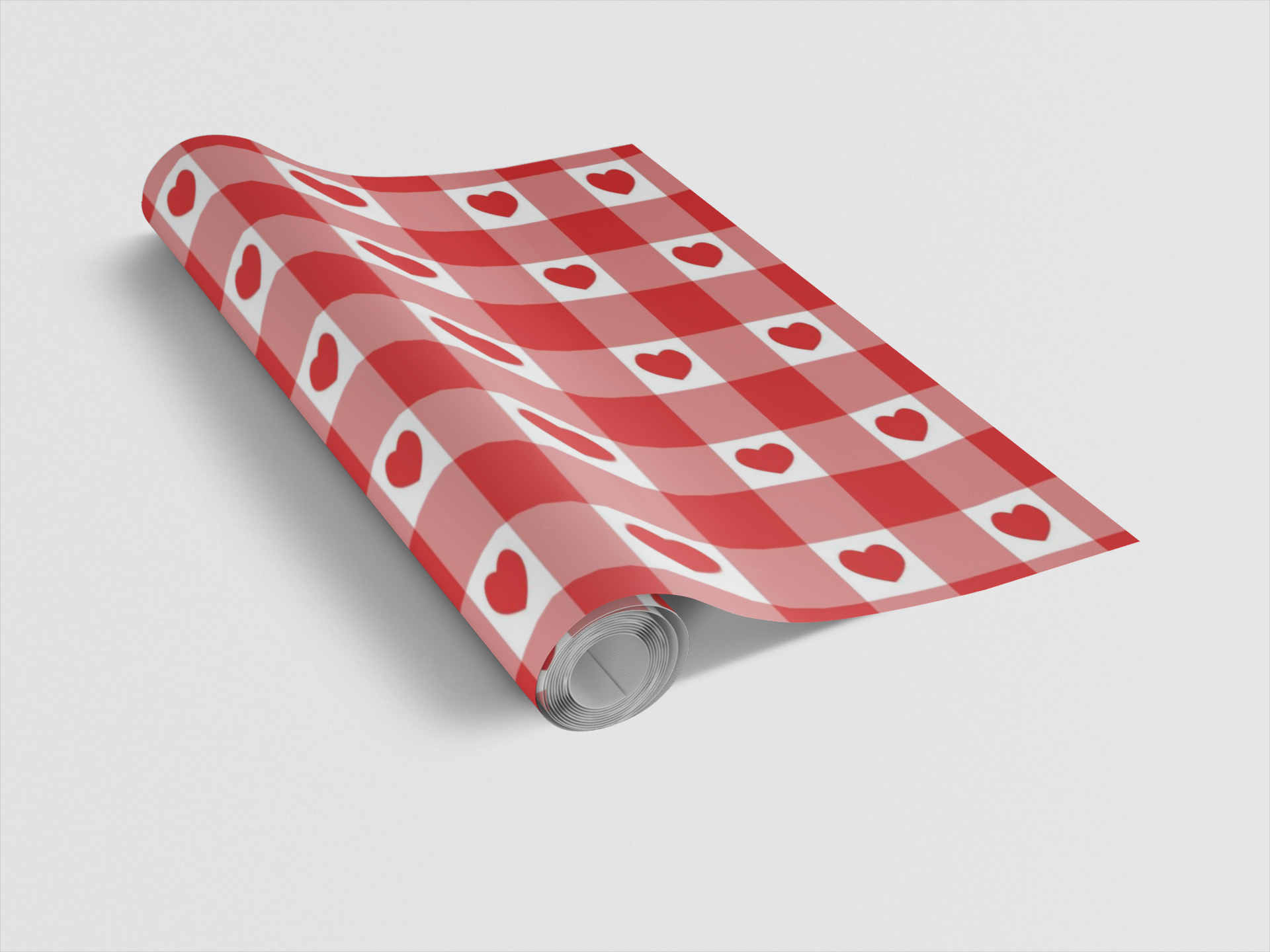 Roll of red and white checkered paper with heart patterns on a light gray background